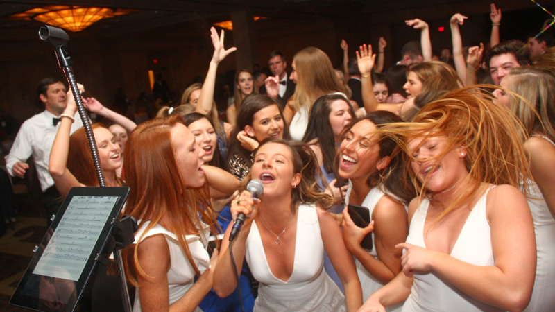A group of young ladies on the dance floor sing to the band at a recent Retrospect Band party