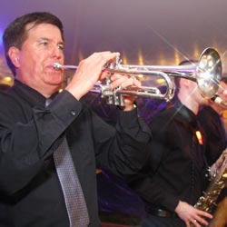 Band leader and trumpet player Larry plays at a summer tent wedding on the Eastern Shore of Maryland